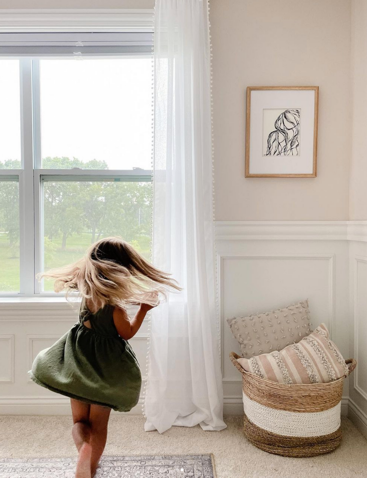 Essence line drawing print in a bright room with a woven basket