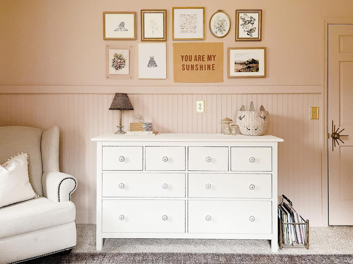 Always Be Kind line drawing print in a gallery wall above a white dresser in a pink nursery