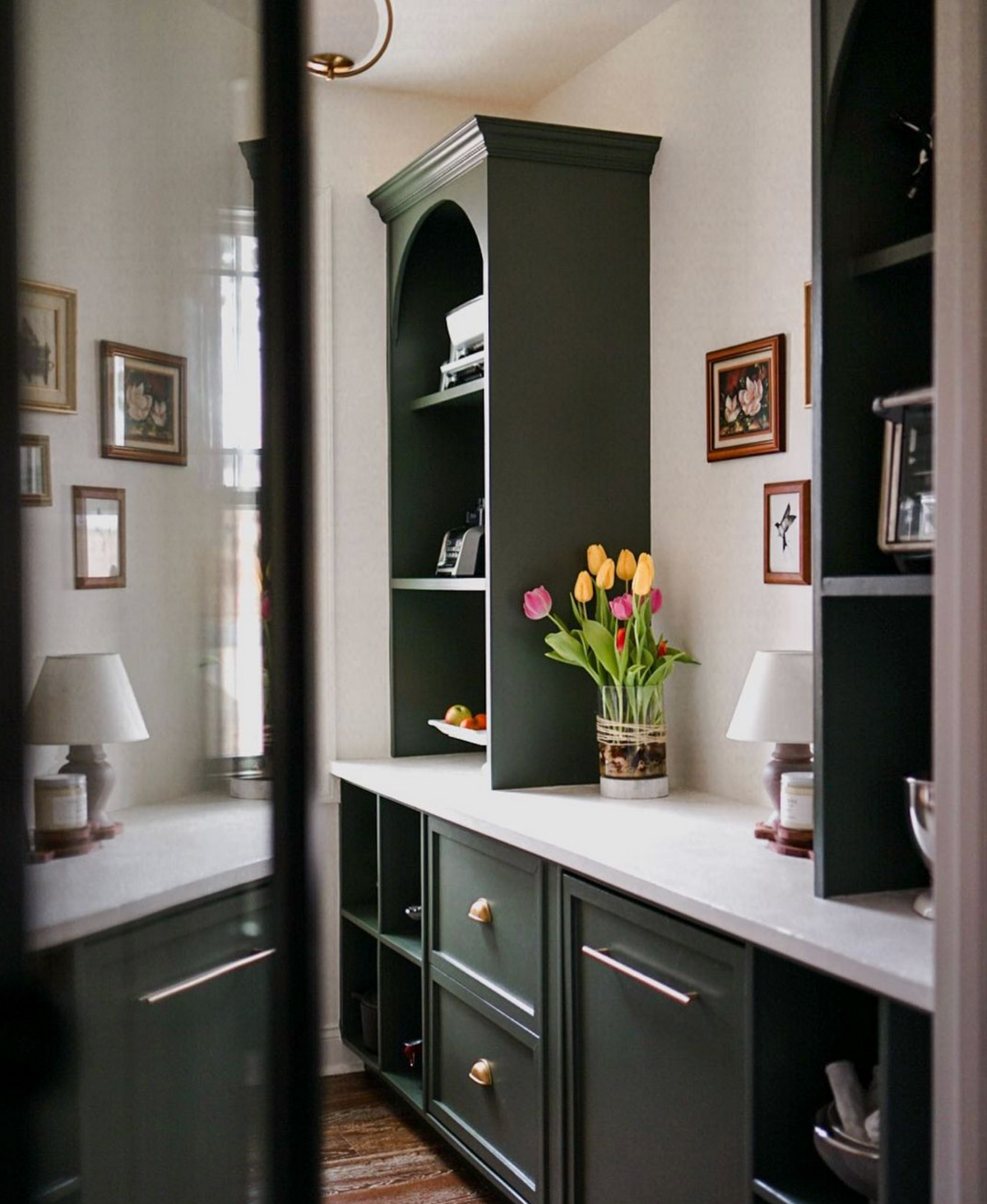 A Soft Place To Land swallow print beside dark green cabinets