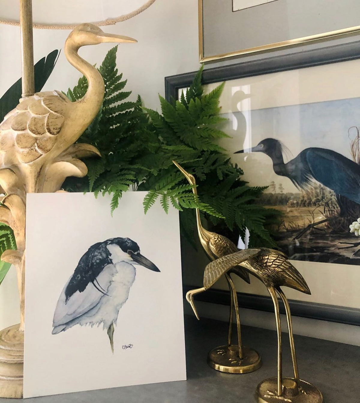 Presence night heron print with brass heron figures and ferns
