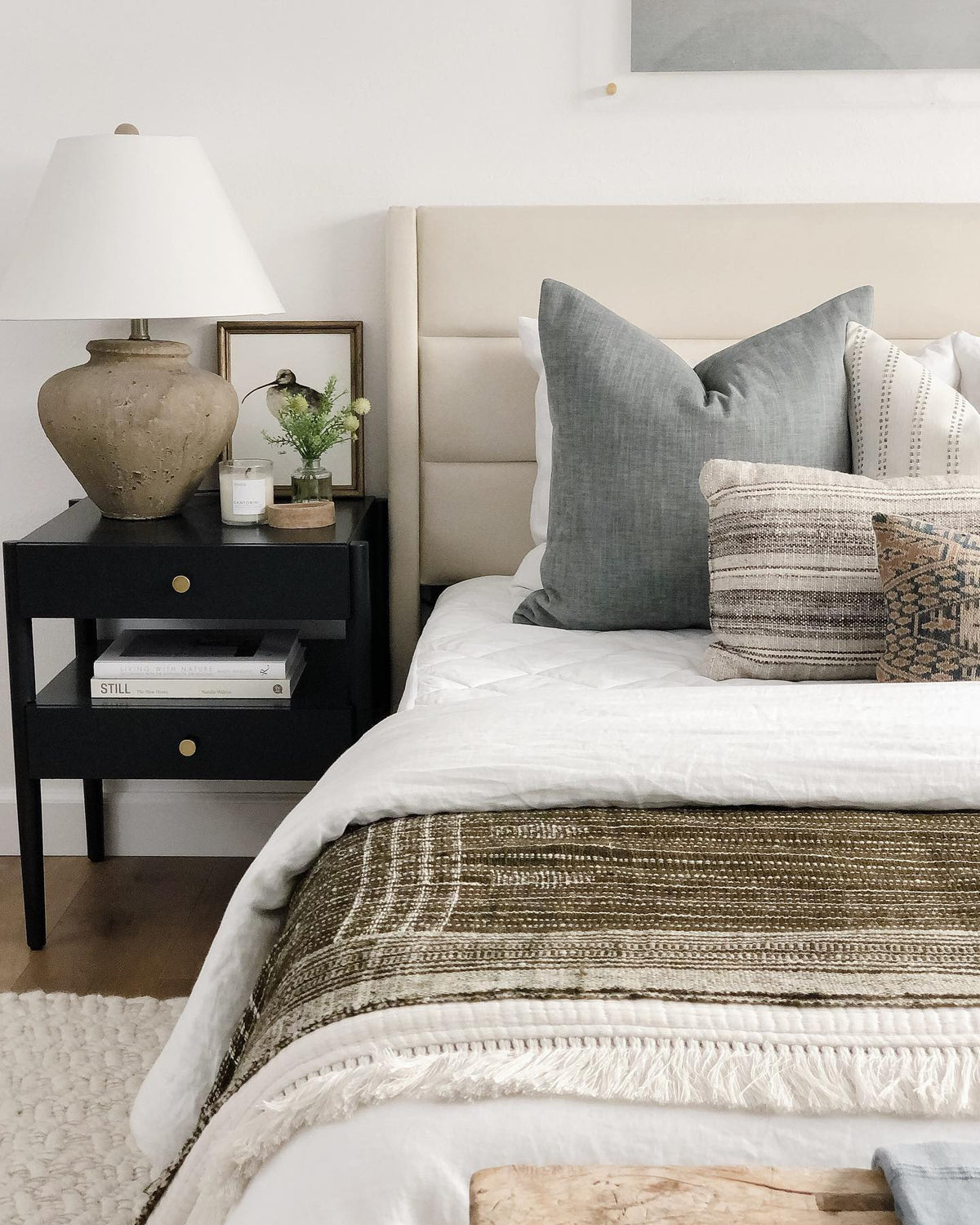 Changing the Game curlew print on a nightstand beside a bed