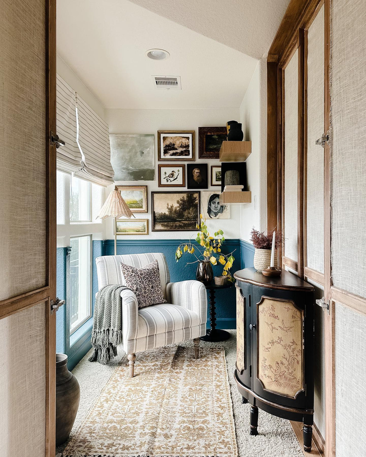 Serendipity sparrow print in a gallery wall in a reading nook with a striped chair